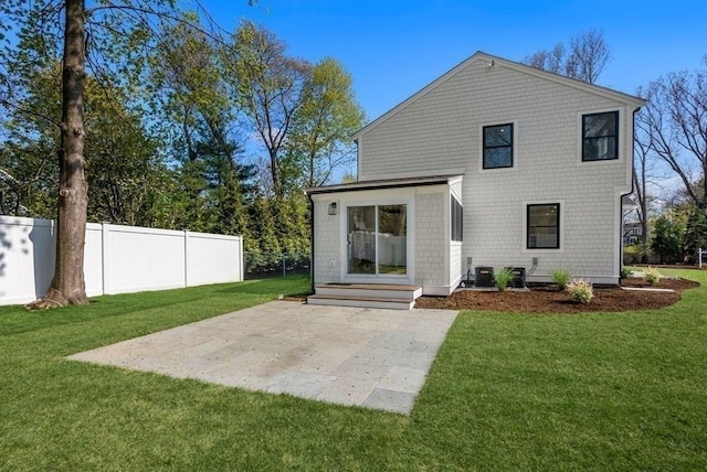 rear view of house featuring a yard and a patio area