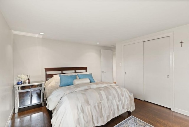 bedroom with recessed lighting, a closet, and wood finished floors