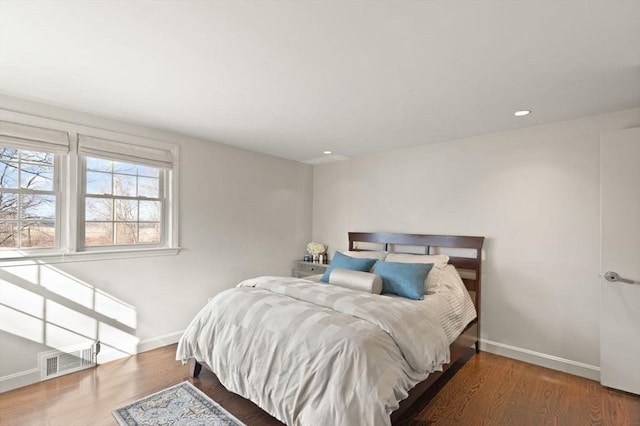 bedroom featuring recessed lighting, visible vents, baseboards, and wood finished floors