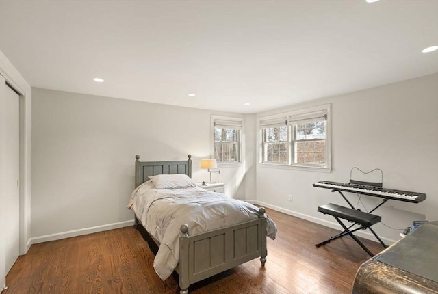 bedroom featuring a closet, recessed lighting, baseboards, and wood finished floors