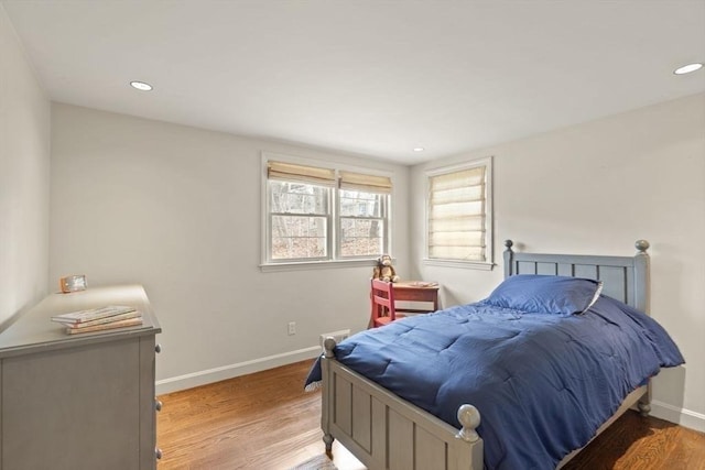 bedroom with recessed lighting, light wood-style floors, and baseboards