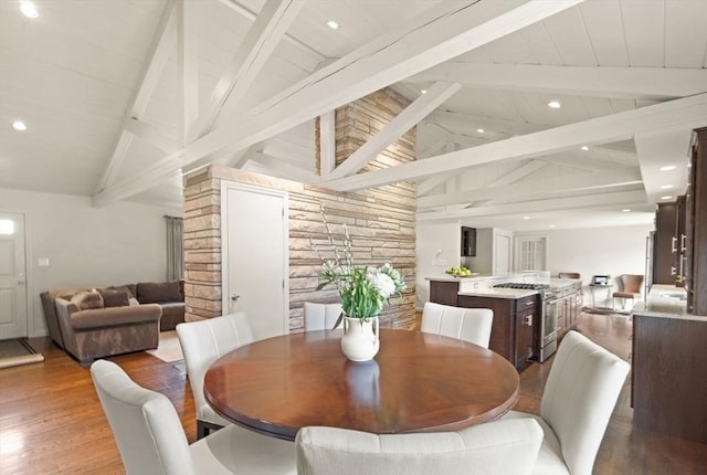 dining area with recessed lighting, wood finished floors, and vaulted ceiling with beams