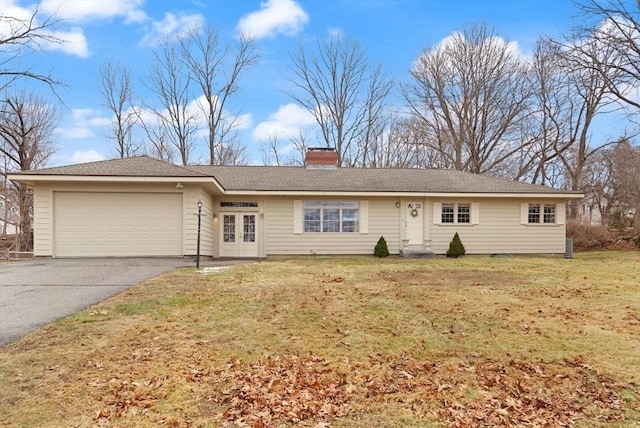 single story home with a front yard, a chimney, french doors, a garage, and aphalt driveway