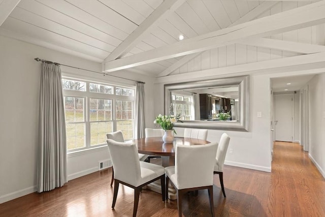 dining area with lofted ceiling with beams, visible vents, wood finished floors, and a wealth of natural light