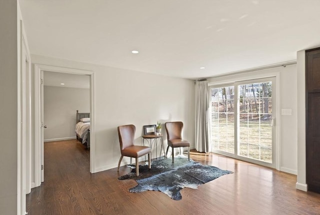 sitting room with recessed lighting, baseboards, and dark wood-type flooring