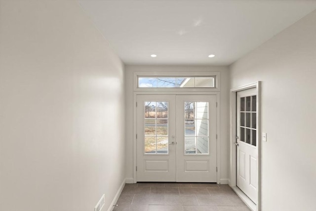 doorway featuring light tile patterned flooring, recessed lighting, french doors, and baseboards