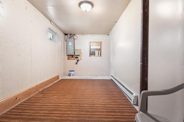 laundry area with baseboard heating and electric panel