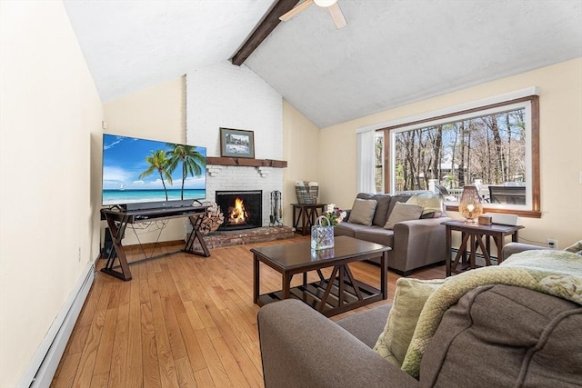 living room featuring a baseboard radiator, wood-type flooring, a fireplace, a ceiling fan, and baseboards