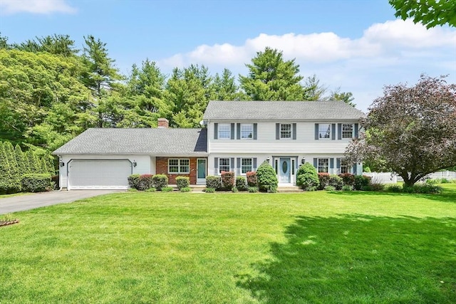 5 Evergreen Cir, Wilbraham, MA 01095 - colonial house with a garage, driveway, a chimney, and a front lawn