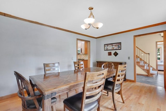 5 Evergreen Cir, Wilbraham, MA 01095 - dining room with baseboards, stairs, ornamental molding, a chandelier, and light wood-style floors