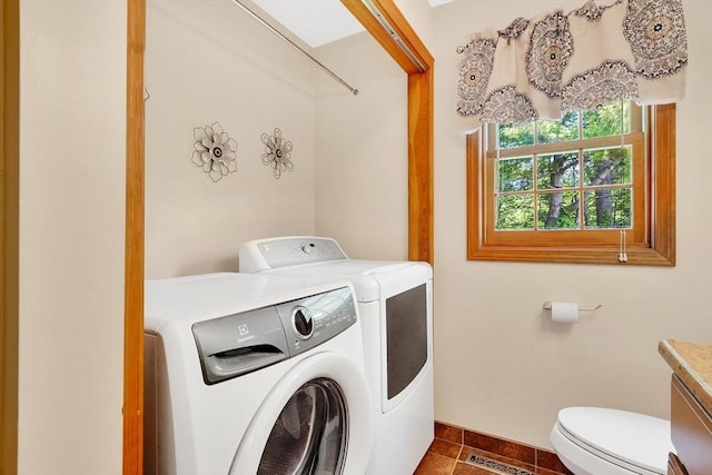 5 Evergreen Cir, Wilbraham, MA 01095 - laundry area featuring separate washer and dryer, dark tile patterned flooring, and baseboards