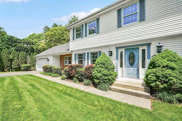5 Evergreen Cir, Wilbraham, MA 01095 - colonial-style house with a front lawn, a garage, and driveway