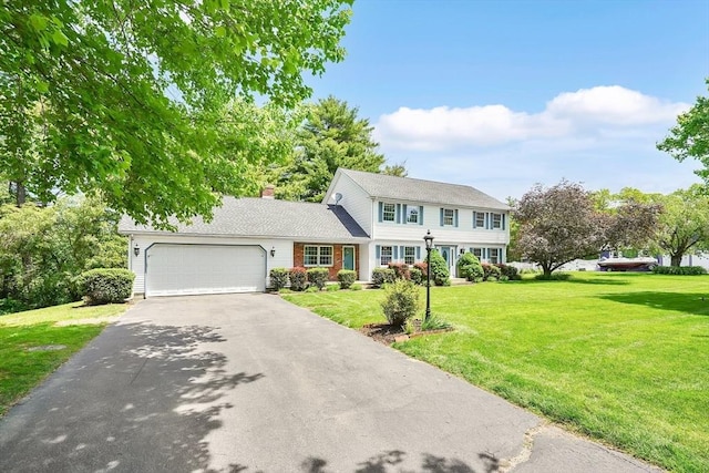 5 Evergreen Cir, Wilbraham, MA 01095 - colonial house with driveway, an attached garage, a front yard, and a chimney