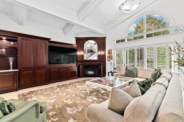 living area featuring beam ceiling and a glass covered fireplace