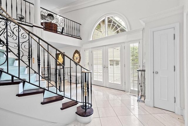 tiled entryway with french doors and stairs