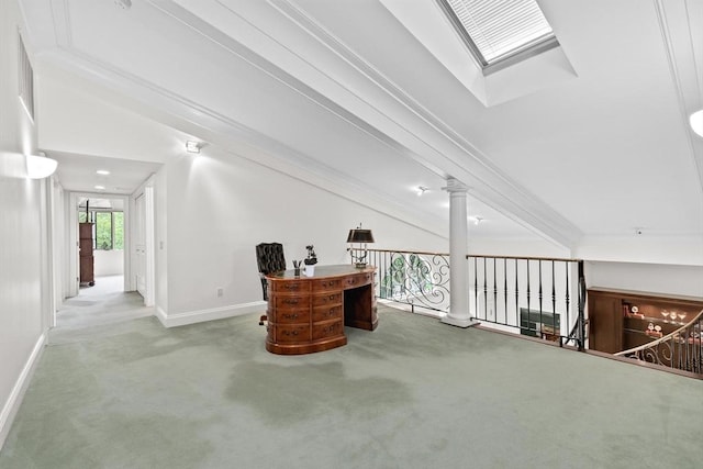 carpeted home office featuring ornate columns, baseboards, crown molding, and a skylight