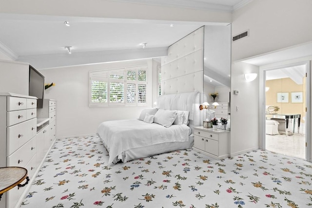 bedroom featuring crown molding, lofted ceiling, and baseboards