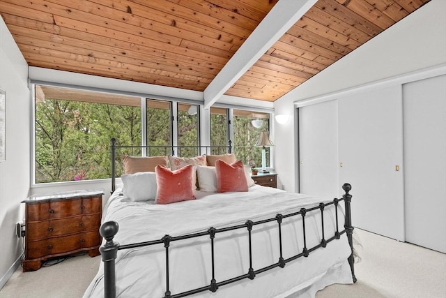 carpeted bedroom featuring wood ceiling, multiple windows, and a closet