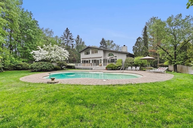 view of pool with a wooden deck and a patio