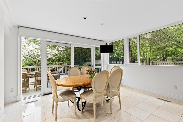 dining area featuring baseboards and light tile patterned floors