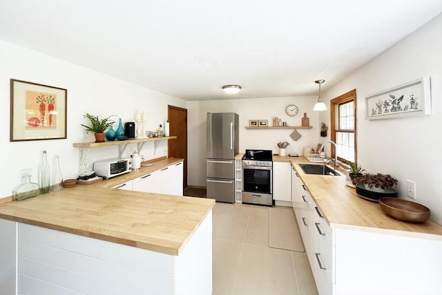 120 Tracy Cir, Amherst, MA 01002 - kitchen featuring open shelves, stainless steel appliances, a sink, a peninsula, and white cabinets
