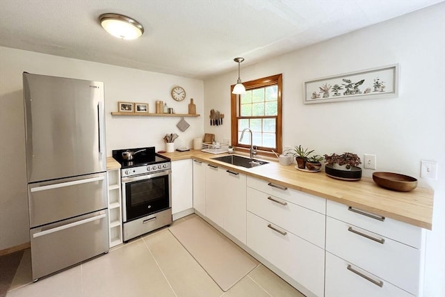120 Tracy Cir, Amherst, MA 01002 - kitchen with stainless steel appliances, a sink, wood counters, open shelves, and white cabinetry