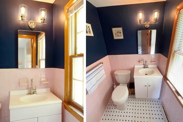 120 Tracy Cir, Amherst, MA 01002 - bathroom with tile walls, toilet, two vanities, and a wainscoted wall