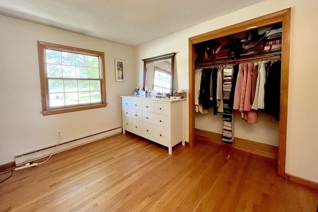 120 Tracy Cir, Amherst, MA 01002 - bedroom featuring a baseboard heating unit, light wood-style floors, a closet, and baseboards