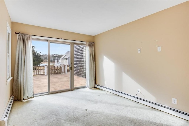 carpeted spare room with a baseboard radiator