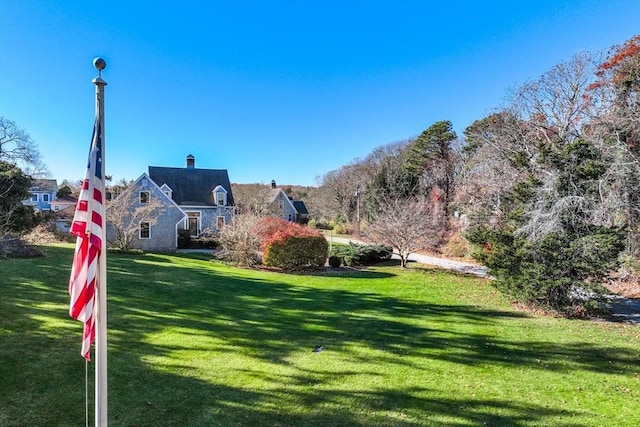 view of property's community with a lawn