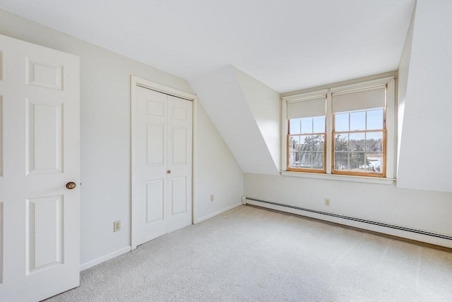 bonus room featuring vaulted ceiling, light colored carpet, and a baseboard radiator