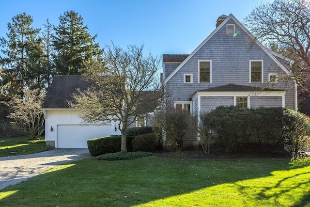 view of side of home with a garage and a yard