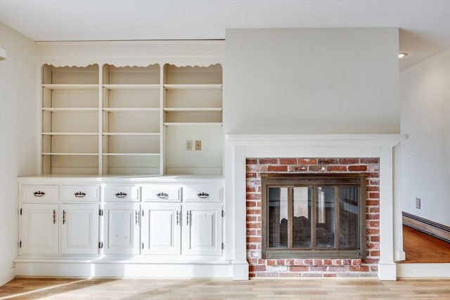 unfurnished living room with a fireplace and light hardwood / wood-style flooring