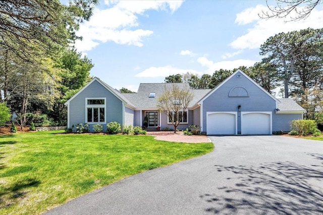 view of front of property featuring driveway, a front yard, roof with shingles, and an attached garage