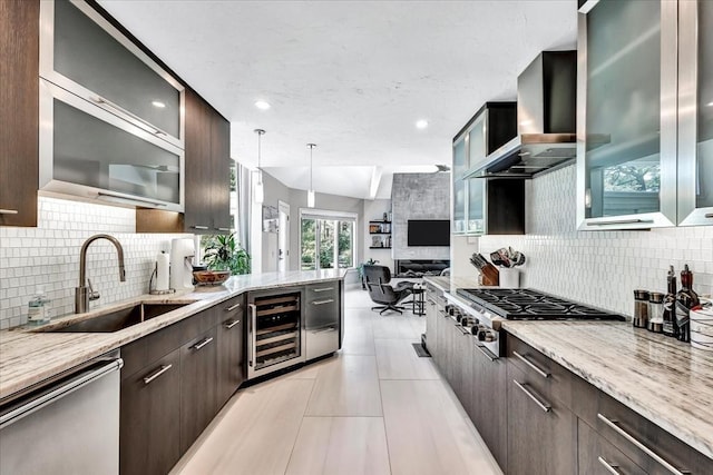 kitchen featuring a sink, stainless steel appliances, wine cooler, and dark brown cabinets