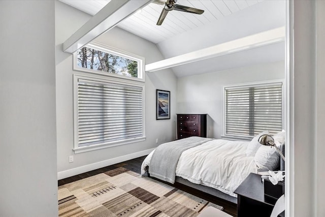 bedroom with a ceiling fan, vaulted ceiling, wood finished floors, and baseboards