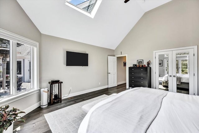 bedroom with dark wood-style floors, multiple windows, baseboards, and a skylight