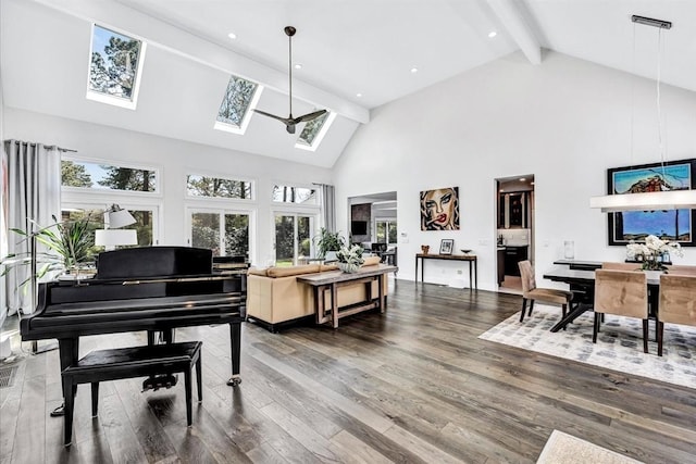 living area with beam ceiling, high vaulted ceiling, wood finished floors, recessed lighting, and a skylight