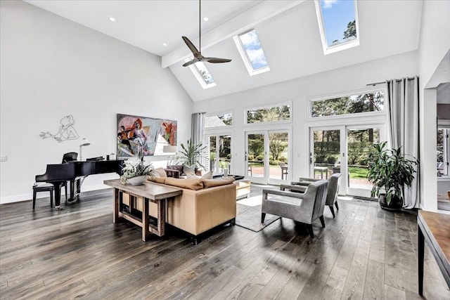 living room featuring dark wood-type flooring, high vaulted ceiling, french doors, a skylight, and baseboards