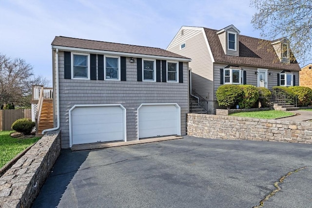 12 Jacobs Ave, Danvers, MA 01923 - view of front of property with stairs, a garage, asphalt driveway, and a shingled roof