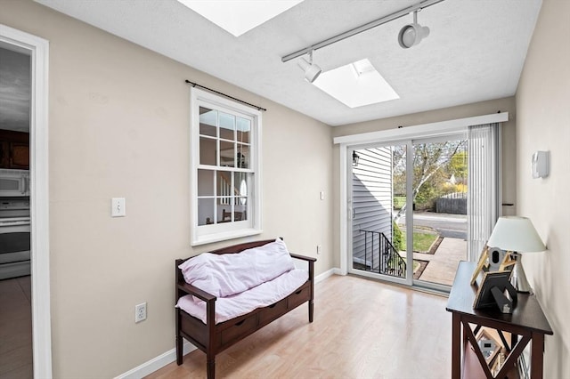 12 Jacobs Ave, Danvers, MA 01923 - living area with a skylight, light wood-style flooring, track lighting, and baseboards