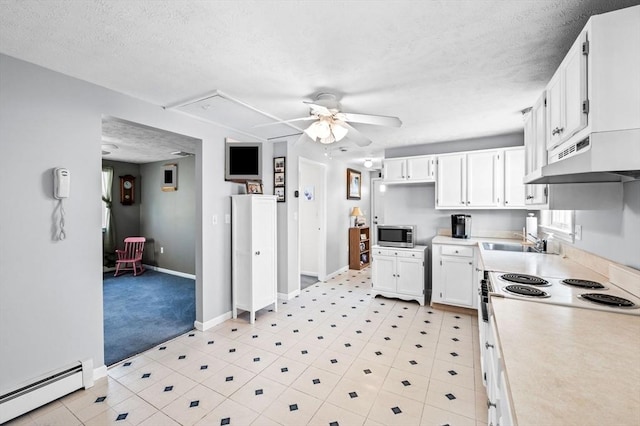 12 Jacobs Ave, Danvers, MA 01923 - kitchen featuring a baseboard heating unit, stainless steel microwave, ceiling fan, a textured ceiling, and under cabinet range hood