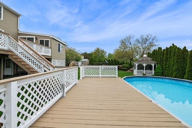 12 Jacobs Ave, Danvers, MA 01923 - swimming pool featuring a gazebo, a wooden deck, a storage unit, and an outdoor structure