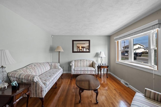 12 Jacobs Ave, Danvers, MA 01923 - living area featuring a textured ceiling, baseboards, and wood finished floors