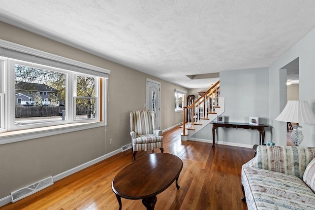12 Jacobs Ave, Danvers, MA 01923 - living area with stairway, a textured ceiling, baseboards, and wood finished floors