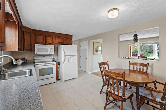 12 Jacobs Ave, Danvers, MA 01923 - kitchen with white appliances, a sink, light tile patterned flooring, and baseboards