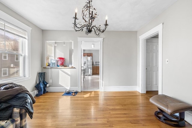 dining room featuring hardwood / wood-style floors and an inviting chandelier