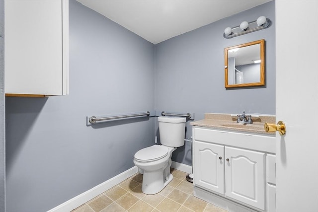 bathroom featuring tile patterned flooring, vanity, and toilet