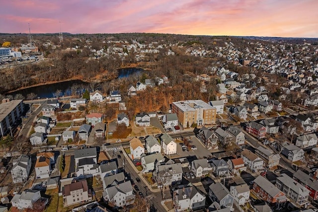 aerial view at dusk with a water view