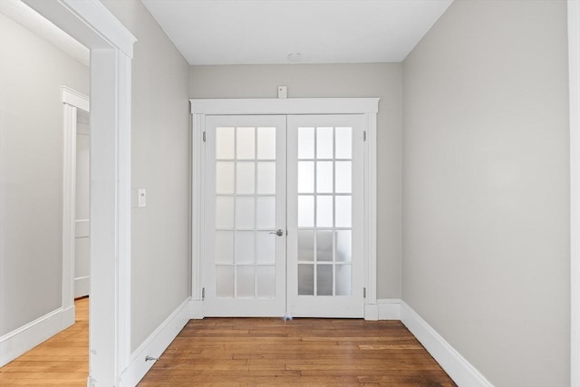 entryway featuring light hardwood / wood-style floors and french doors